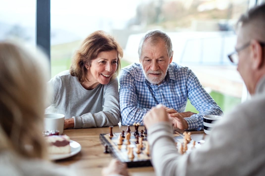 Group of Senior People Playing Board Game Indoors